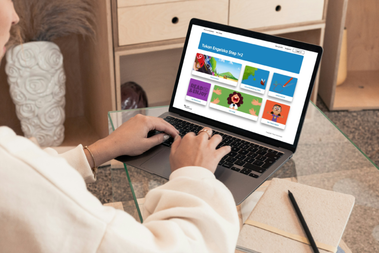 A person who uses Tukan Digital's interactive learning platform on a laptop for digital instruction and educational materials.