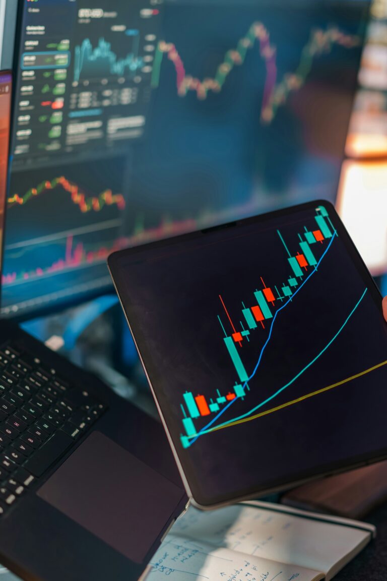 Laptop displaying charts and key metrics in a dark interface
