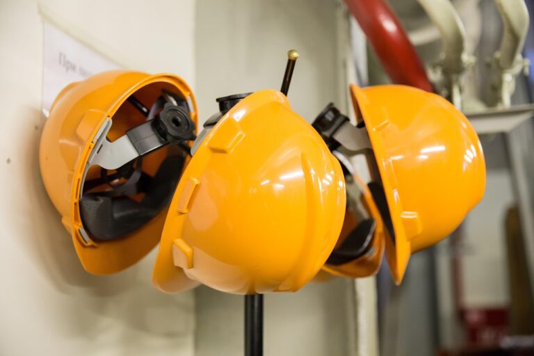 Orange safety helmets for safety and occupational health in industrial factory settings