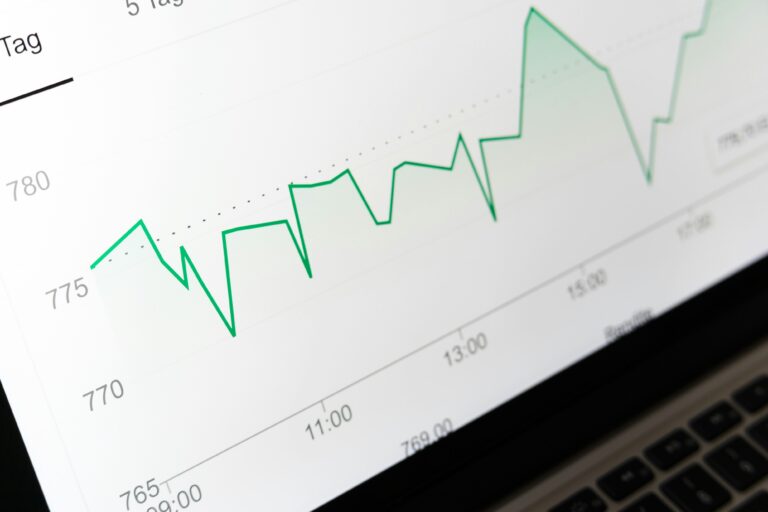 Close-up of a green line graph over time on a laptop screen